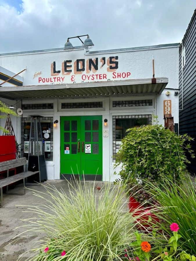 Leon’s Poultry and Oyster Shop entrance with greenery.