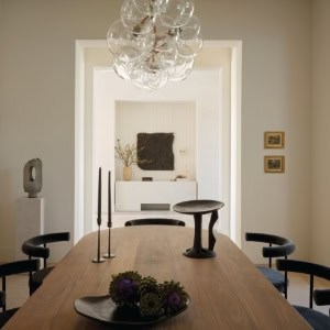 Modern dining room with stylish decor and lighting.