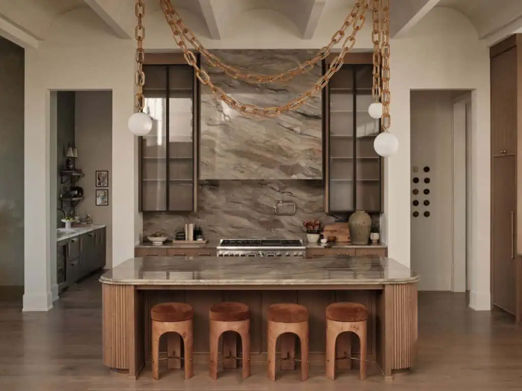 Modern kitchen with marble island and wood accents.