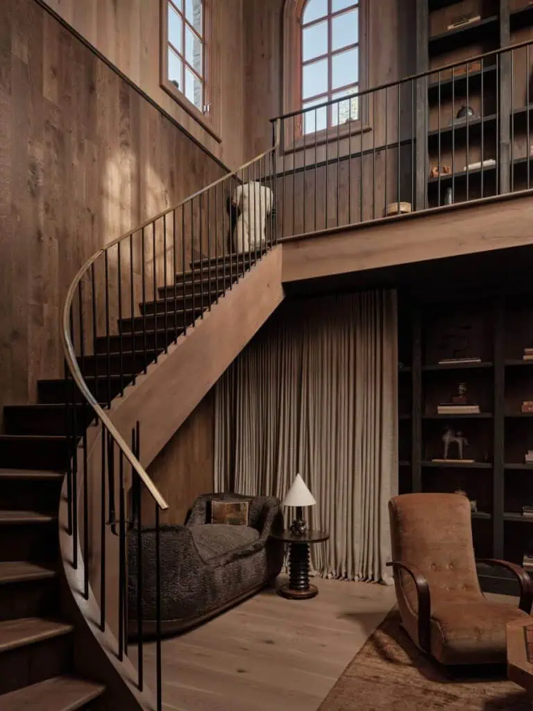 Cozy wooden interior with curved staircase and armchairs.