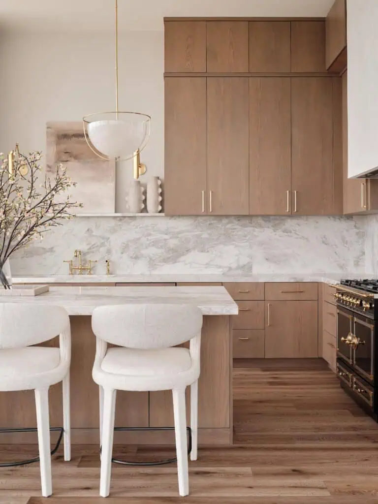 Modern kitchen with wooden cabinets and marble countertops.