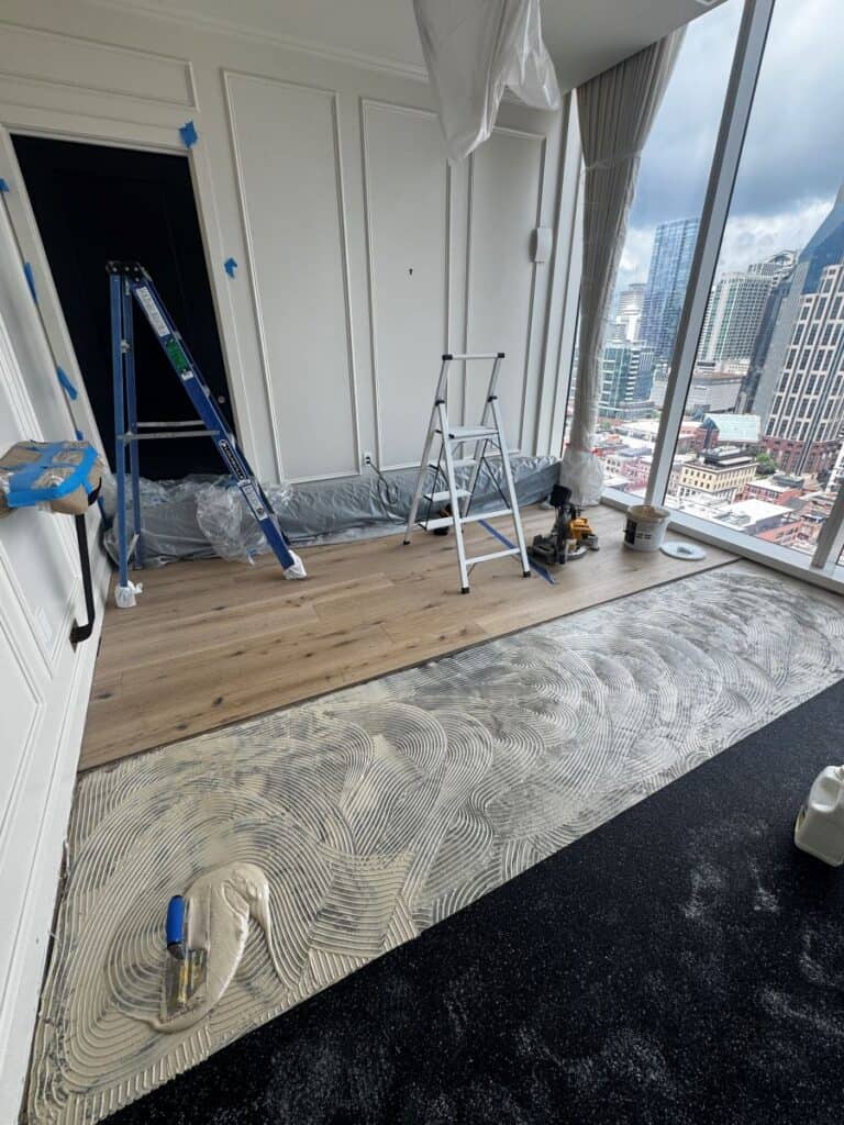 Room under renovation with new flooring installation.