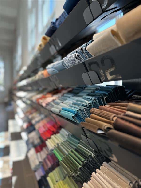 Colorful fabric rolls displayed on shelves in store