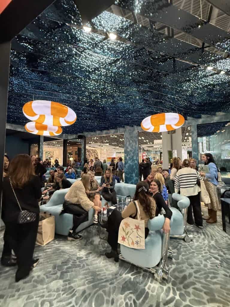 Group socializing in modern lounge with unique ceiling design.