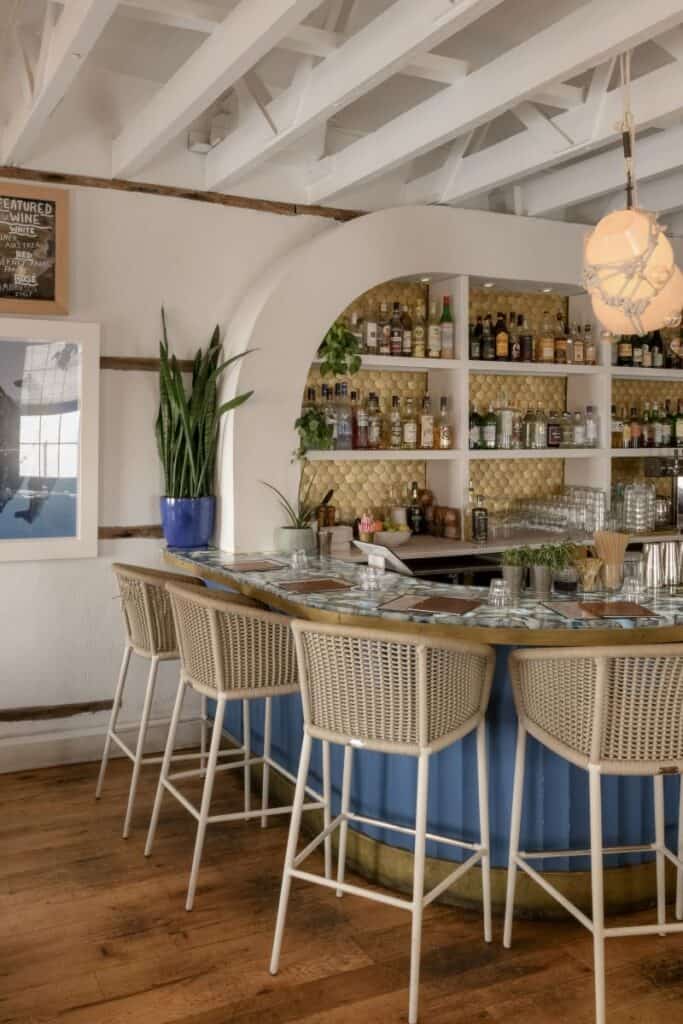 Elegant bar with blue accents and wicker stools