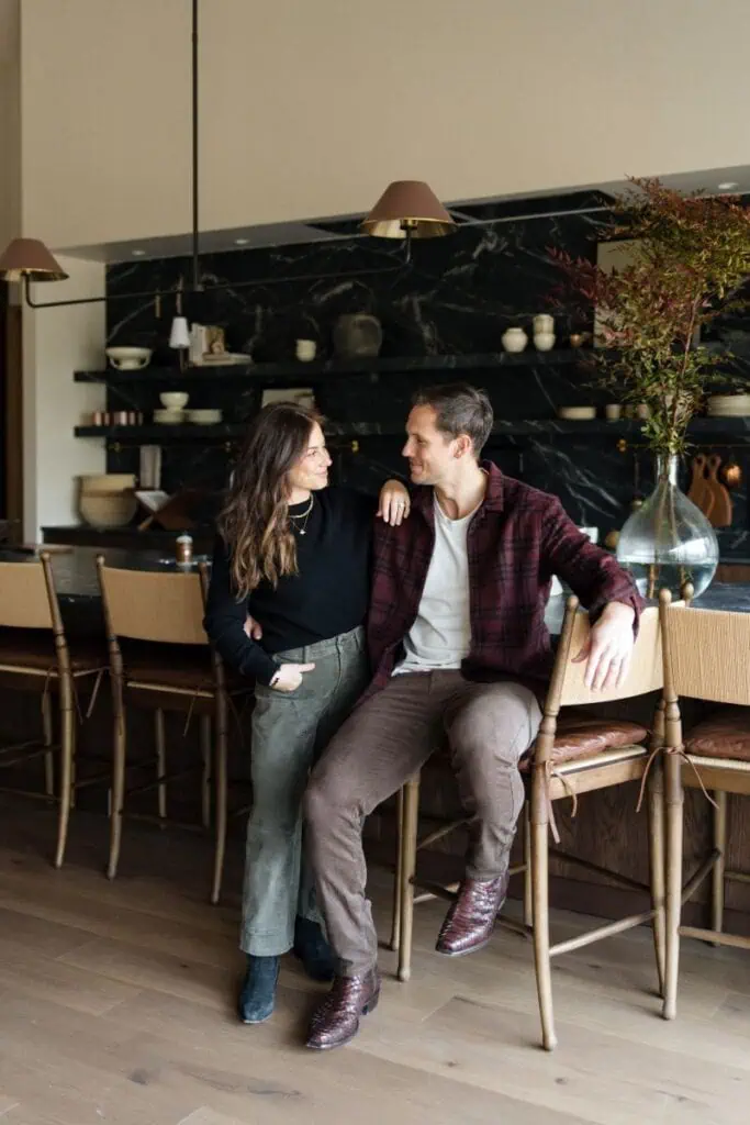 Couple smiling in cozy modern kitchen