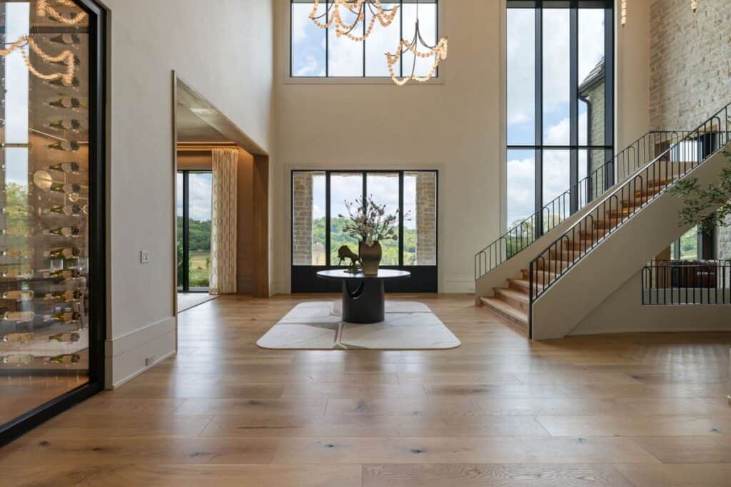 Modern luxury foyer with staircase and large windows