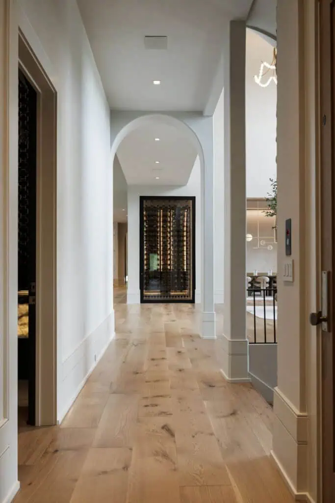 Modern hallway with arched ceiling and glass wine cellar